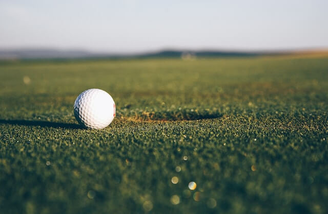 white golf ball on grass green Golf Club Land